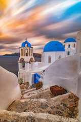 View on the picturesque church with the three blue domes at dusk, Santorini island GR