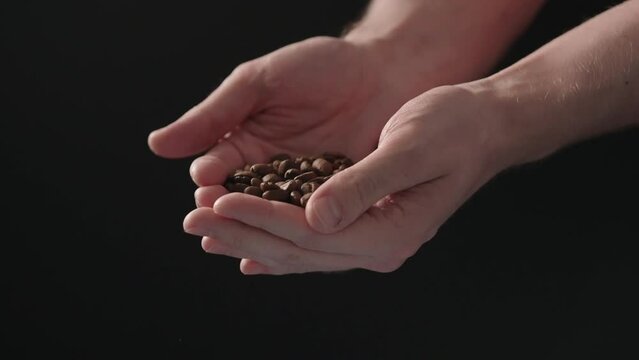 Slow motion mam pour coffee beans over balck background
