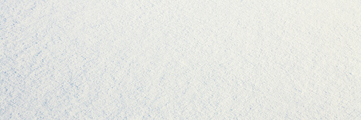 Natural snow texture. Smooth surface of clean fresh snow. Snowy ground. Winter background with snow patterns. Perfect for Christmas and New Year design. Closeup top view.