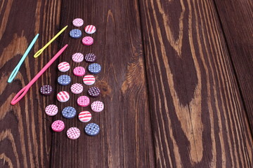 Group of buttons for sewing work on wooden table