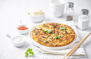 Cabbage omelet with cilantro leaves in a plate