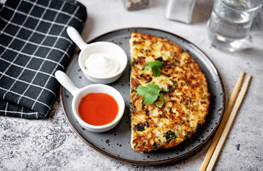 Cabbage omelet with cilantro leaves in a plate