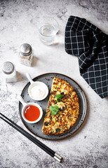 Cabbage omelet with cilantro leaves in a plate