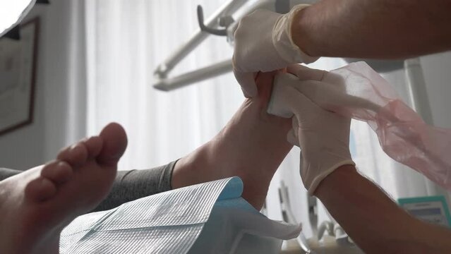 Contemporary laser scanner in medical centre for examining human feet and establishing diagnosis, professional podiatrist examining patient's foot with medial equipment and receiving scanning results