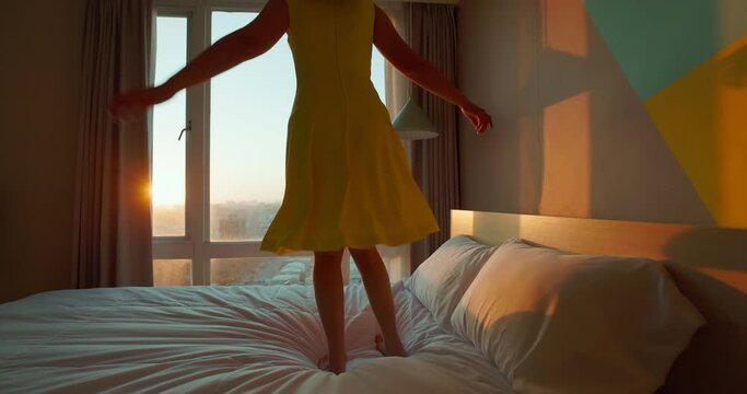 happy woman jump on bed