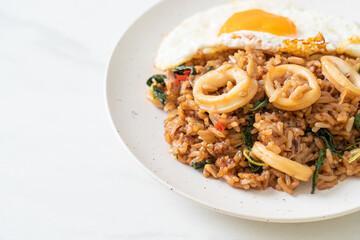 fried rice with squid and basil topped fried egg in Thai style