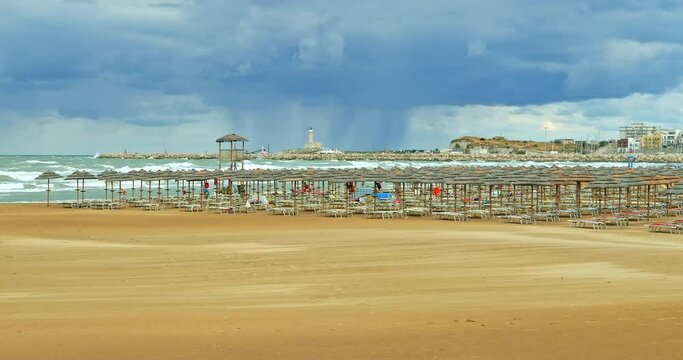 Vieste (Apulia) beach deserted due to the arrival of a storm. The beach umbrellas have all been closed
