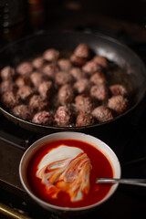 Homemade beef meatballs cooked with tomato and sour cream sauce.