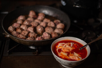 Homemade beef meatballs cooked with tomato and sour cream sauce.