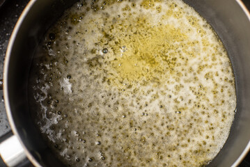 Melt the butter in a saucepan. The initial stage of preparing the sauce
