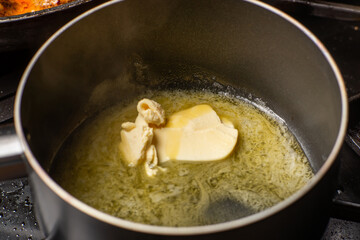 Melt the butter in a saucepan. The initial stage of preparing the sauce