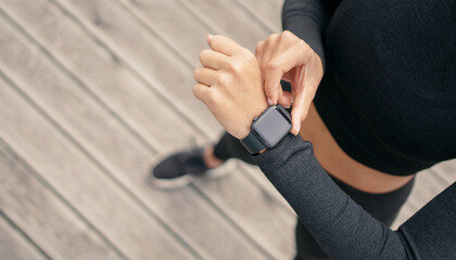 The display is a smart watch for fitness, a woman measures the results of a workout. Copy space.