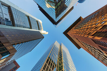 Looking up at skyscrapers in the banking district of Frankfurt - obrazy, fototapety, plakaty