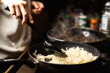 Roasting onions. Chopped onions are fried in a pan. Cooking food.