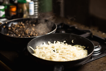 Roasting onions. Chopped onions are fried in a pan. Cooking food.