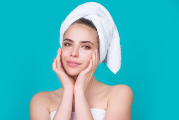 Woman applying eye patches. Close up portrait of girl with collagen pad patches under eyes, taking care of delicate skin around eyes. Woman patches rejuvenation skin care. © Volodymyr