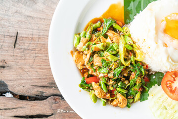 rice and stir fried chicken with basil and fried egg on top