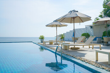 Fototapeta na wymiar bed pool around swimming pool with sea background