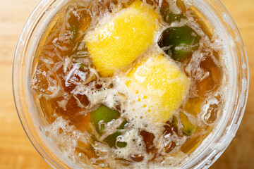 top view cup of iced lemon tea close up