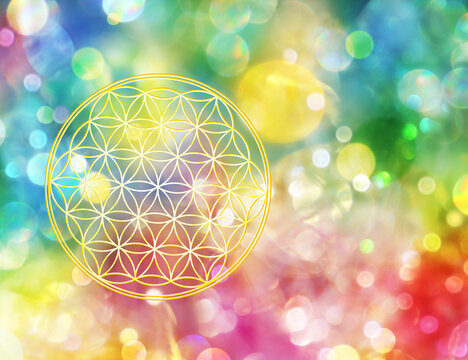 Symbol einer golden schimmernden Blume des Lebens in  einem funkelden Lichterfeld strahlender Farbenvielfalt 
