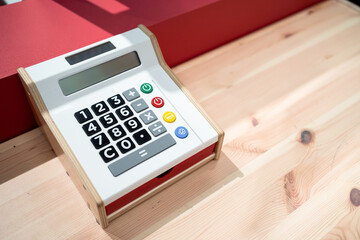 Wooden calculator on wooden table. Toy calculator. Finance concept