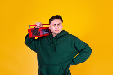 A handsome guy with a boombox on a yellow background