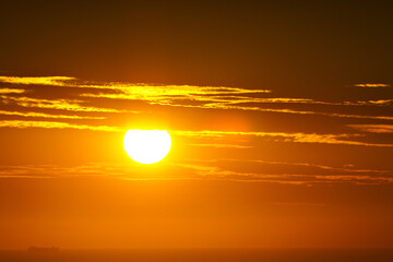 A view of a beautiful orange sunrise over the ocean.