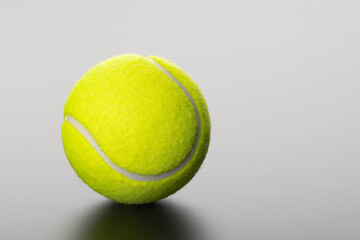 tennis ball on grey background with copy space
