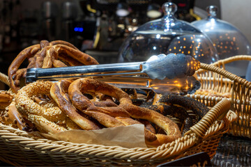 Pretzel with cinnamon, sesame seeds and poppy seeds in a basket