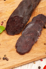 Horse sausage mahan sliced on a wooden board top view