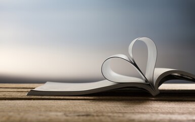 Love concept. Open reading book an pages in heart form