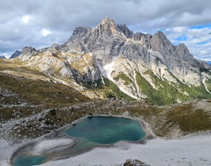 Beautiful turquoise waters of a little mountain lake in the Dolomites