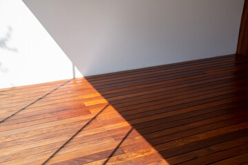 Interior flooring cumaru wood texture in sun light and shadow contrast