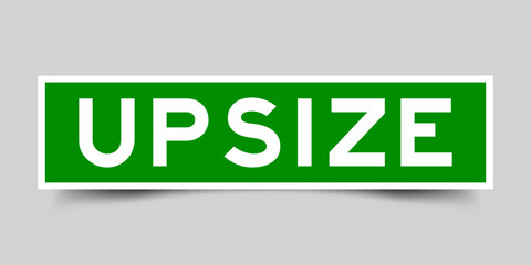 Green color square shape sticker label with word upsize on gray background