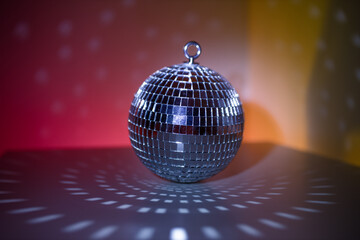 Disco ball close-up on neon background. Glow and flashes of light. Disco. Preparation for the party.
