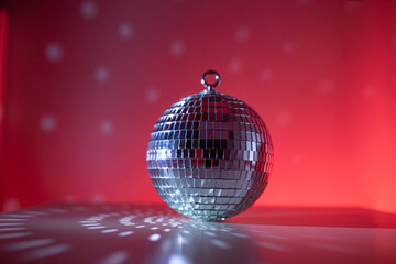 Disco ball close-up on neon background. Glow and flashes of light. Disco. Preparation for the party.
