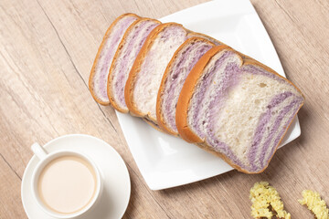 Sliced bread with taro and coffee on wooden background