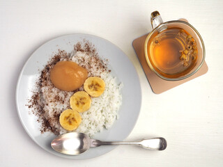 White rice, banana slices, applesauce and chamomile tea