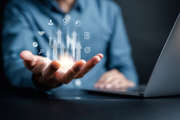 Businessman holding increase up icon with business objective to set up business objective target goal, marketing solution, target for business investment.