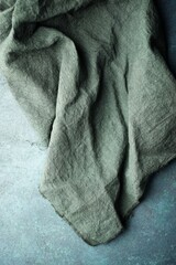 Fototapeta na wymiar Green kitchen towel on a table