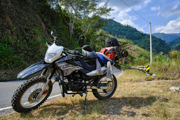 Detail of a motorcycle parked on the road during a trip to the interior of the country.