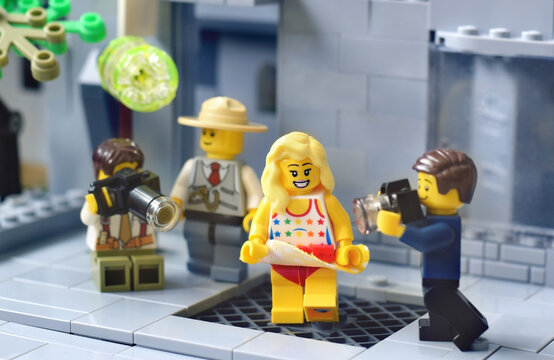 Lego minifigure of actress like Marilyn Monroe over a  subway grate. A skirt is blowing. Editorial illustrative image of popular plastic toys brand. minifigure girl with vent skirt