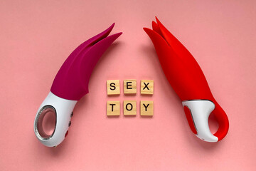 Sex toys. Two red vibrators on a pink background. lettering SEX TOY. Useful for sex shop, adults