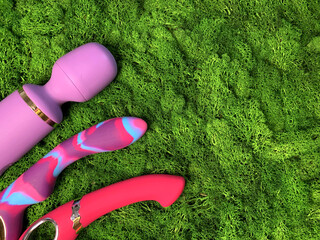 Three vibrators on green backgrund. Sex toys for adult game. Sex shop assortment. Sex massager,...