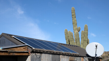A solar panel on an old Arizona shack