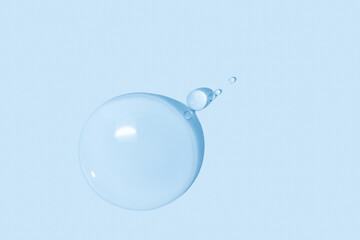 large drops of transparent Gel liquid, water on a blue background, top view, close-up