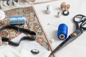 Thread scissors and black tape lie on fabric..