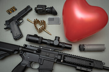 Tactical equipment and Valentine's day. Ar 15 rifle, silencer, M1911 pistol, heart made of bullets, heart shaped balloon, night vision device and American flag patch