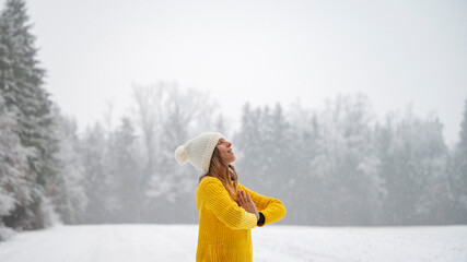 Young woman meditating in winter nature - 568062450