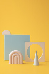 Composition from toys on light background. Easter or baby background and Banner design elements.
Abstract composition with geometric shapes forms.  A place to insert text, minimalism. 
